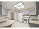 Open kitchen layout featuring light gray cabinetry, spacious countertops, and modern appliances at 24 Brigadoon Cir, Leesburg, FL 34788