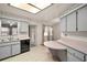 Well-lit kitchen with stainless steel sink, black dishwasher, and breakfast bar area at 24 Brigadoon Cir, Leesburg, FL 34788