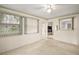 Carpeted room with windows allowing ample natural light with view into the kitchen at 24 Brigadoon Cir, Leesburg, FL 34788