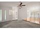 Spacious living room with high ceilings, ceiling fan, and large windows, offering ample natural light at 24 Brigadoon Cir, Leesburg, FL 34788
