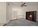 Living room with a ceiling fan, carpet, and a bookcase at 24 Brigadoon Cir, Leesburg, FL 34788