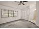 Open floor plan with carpet, windows, and a ceiling fan offering a well lit living space at 24 Brigadoon Cir, Leesburg, FL 34788