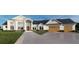 Stunning two-story home with large windows, a three-car garage, and a professionally landscaped yard at 2421 Shady Ln, Groveland, FL 34736