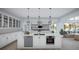 Bright and airy kitchen boasting a large island with a sink, stainless steel appliances, and ample cabinetry at 2421 Shady Ln, Groveland, FL 34736