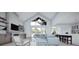 Bright and airy living room with vaulted ceilings, ample natural light, and stylish furniture at 2421 Shady Ln, Groveland, FL 34736
