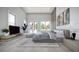 Comfortable primary bedroom featuring a tray ceiling, large windows, and a serene atmosphere at 2421 Shady Ln, Groveland, FL 34736