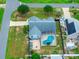 A captivating aerial view of a single-Gathering home, pool, fenced yard, and well-maintained landscaping at 2705 Bayview Dr, Eustis, FL 32726