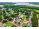 Aerial view highlighting property lines in a lakeside residential area with established trees and lawns at 2705 Bayview Dr, Eustis, FL 32726