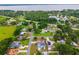 Aerial view pointing out a home in a neighborhood surrounded by greenery, near a lake and highways at 2705 Bayview Dr, Eustis, FL 32726