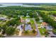 Aerial view of a neighborhood, with property lines marked, surrounded by lush greenery and a lake at 2705 Bayview Dr, Eustis, FL 32726