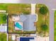 Aerial view of a home with a pool, surrounded by a fenced yard and lush green lawn at 2705 Bayview Dr, Eustis, FL 32726