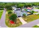 Aerial view of the blue house with long driveway, lush green grass, mature trees, and a fire hydrant on the lawn at 2705 Bayview Dr, Eustis, FL 32726
