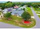 An aerial view of a well-maintained home featuring mature trees, landscape, and a refreshing screened pool at 2705 Bayview Dr, Eustis, FL 32726