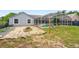 A screened-in pool, a spacious patio area, and lush backyard landscaping create an outdoor oasis at 2705 Bayview Dr, Eustis, FL 32726
