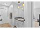 Clean bathroom showcasing vanity with sink, modern lighting, and white wainscoting at 2705 Bayview Dr, Eustis, FL 32726