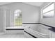 Spacious bathroom featuring a large garden tub with tile surround and window, providing a relaxing and bright atmosphere at 2705 Bayview Dr, Eustis, FL 32726