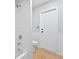 Bright bathroom featuring a shower over tub combination with white tiled walls and neutral walls and tile flooring at 2705 Bayview Dr, Eustis, FL 32726