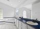 Elegant bathroom with double sinks, a large mirror, and a soaking tub, creating a spa-like retreat for relaxation and self-care at 2705 Bayview Dr, Eustis, FL 32726