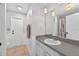 Bright bathroom featuring a vanity with sink, contemporary lighting, and neutral tile flooring at 2705 Bayview Dr, Eustis, FL 32726