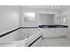 Relaxing bathroom features a soaking tub, double sinks, and plenty of natural light at 2705 Bayview Dr, Eustis, FL 32726