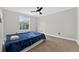 Cozy bedroom with a ceiling fan, wood-look floors, and a bright window for natural light at 2705 Bayview Dr, Eustis, FL 32726