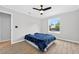 Inviting bedroom featuring a ceiling fan, wood-look flooring, and a window overlooking the backyard at 2705 Bayview Dr, Eustis, FL 32726