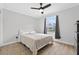 Serene bedroom with wood-look flooring, a ceiling fan, and a window providing natural light at 2705 Bayview Dr, Eustis, FL 32726