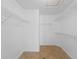Organized walk-in closet with shelving and tile flooring, offering ample storage and a practical design at 2705 Bayview Dr, Eustis, FL 32726
