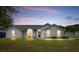 Charming single-story home with a well-maintained lawn and complemented by elegant arched windows at 2705 Bayview Dr, Eustis, FL 32726