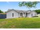 Well-maintained single-story home featuring arched windows, fresh landscaping, and a manicured front lawn at 2705 Bayview Dr, Eustis, FL 32726