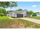 A charming single-story home features a two-car garage, well-manicured lawn, and mature landscaping at 2705 Bayview Dr, Eustis, FL 32726