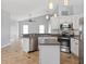 Contemporary kitchen boasts stainless steel appliances, a center island, and ample counter space, ideal for cooking and entertaining at 2705 Bayview Dr, Eustis, FL 32726