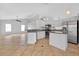 Open-concept kitchen features stainless steel appliances, an island, and seamless flow to the living area, perfect for gatherings at 2705 Bayview Dr, Eustis, FL 32726