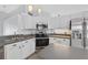 Updated kitchen features stainless steel appliances, white cabinets, and modern fixtures, offering a stylish and functional cooking space at 2705 Bayview Dr, Eustis, FL 32726