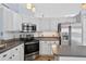Updated kitchen features stainless steel appliances, white cabinets, and modern fixtures, offering a stylish and functional cooking space at 2705 Bayview Dr, Eustis, FL 32726