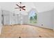 Bright and spacious living room with tile flooring, ceiling fan and an open concept design, perfect for Gathering gatherings at 2705 Bayview Dr, Eustis, FL 32726