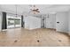 Spacious living room featuring neutral tile flooring, high ceilings, and sliding doors to the outdoor pool area at 2705 Bayview Dr, Eustis, FL 32726
