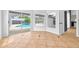 Open living room with tile floors and windows overlooking a pool, bringing the outdoors in for relaxed living at 2705 Bayview Dr, Eustis, FL 32726