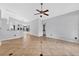 Bright living room boasts a ceiling fan, neutral walls, and tile flooring, creating a cozy yet open space for relaxation at 2705 Bayview Dr, Eustis, FL 32726