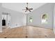 Spacious main bedroom featuring a ceiling fan, two windows, and an adjoining ensuite for added convenience at 2705 Bayview Dr, Eustis, FL 32726