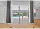 View from inside looking onto the screened patio and pool area with well-maintained landscaping at 2705 Bayview Dr, Eustis, FL 32726