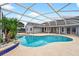 View of a screened-in pool with a well-maintained deck, offering a perfect outdoor oasis at 2705 Bayview Dr, Eustis, FL 32726