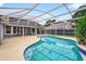 Lush backyard featuring a screened-in pool with blue tile accents and a spacious patio area at 2705 Bayview Dr, Eustis, FL 32726