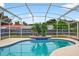 Inviting pool with blue tile and a serene setting, perfect for relaxation and backyard enjoyment at 2705 Bayview Dr, Eustis, FL 32726