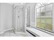 Well-lit bathroom featuring a glass-enclosed shower and bright window, offering a clean and open design at 2705 Bayview Dr, Eustis, FL 32726