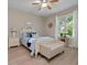 Cozy bedroom features wood floors, natural light, and a comfortable sitting bench at 27121 White Plains Way, Leesburg, FL 34748