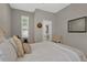 Cozy bedroom features a queen-size bed with a headboard, and natural light from a window with shutters at 27121 White Plains Way, Leesburg, FL 34748