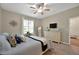 Relaxing bedroom featuring wood floors, a ceiling fan, and soft, natural light at 27121 White Plains Way, Leesburg, FL 34748