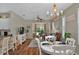 Bright open-concept dining room and living room with hardwood floors and large windows at 27121 White Plains Way, Leesburg, FL 34748