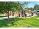 Charming home exterior with manicured lawn and tasteful landscaping at 27121 White Plains Way, Leesburg, FL 34748